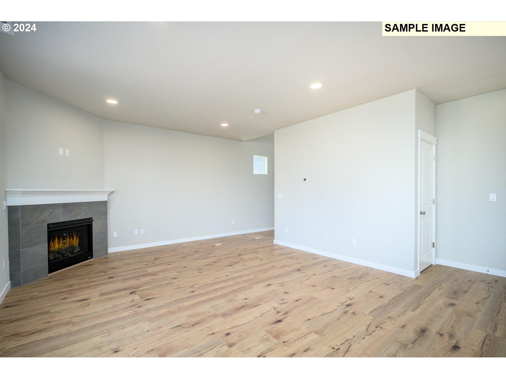 10572 Southeast Heritage Road, Unit 308 Happy Valley, OR 97086 - Photo 5 of 22 a view of an empty room and wooden floor