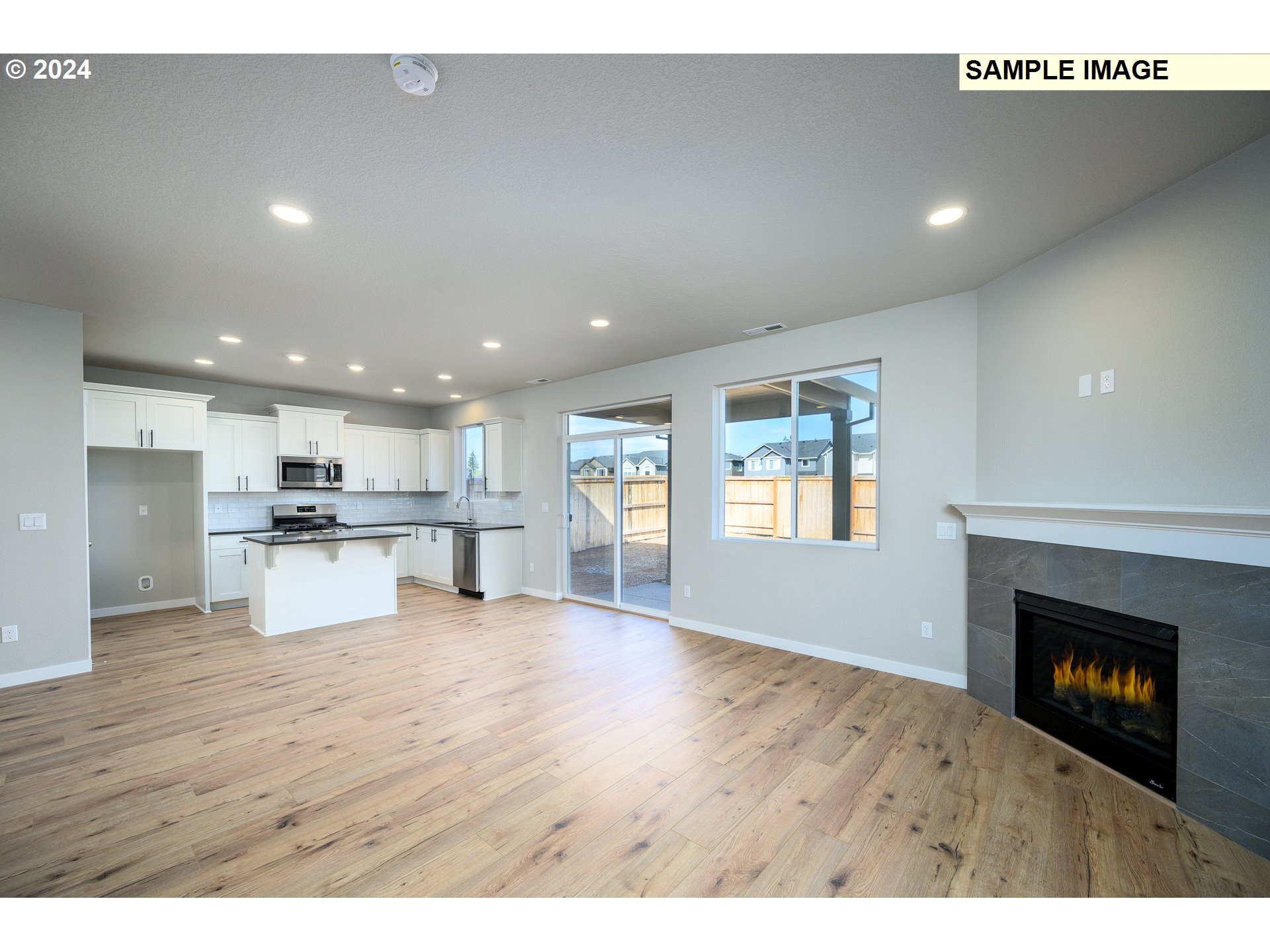 10572 Southeast Heritage Road, Unit 308 Happy Valley, OR 97086 - Photo 6 of 22 a view of kitchen with kitchen island and wooden floor