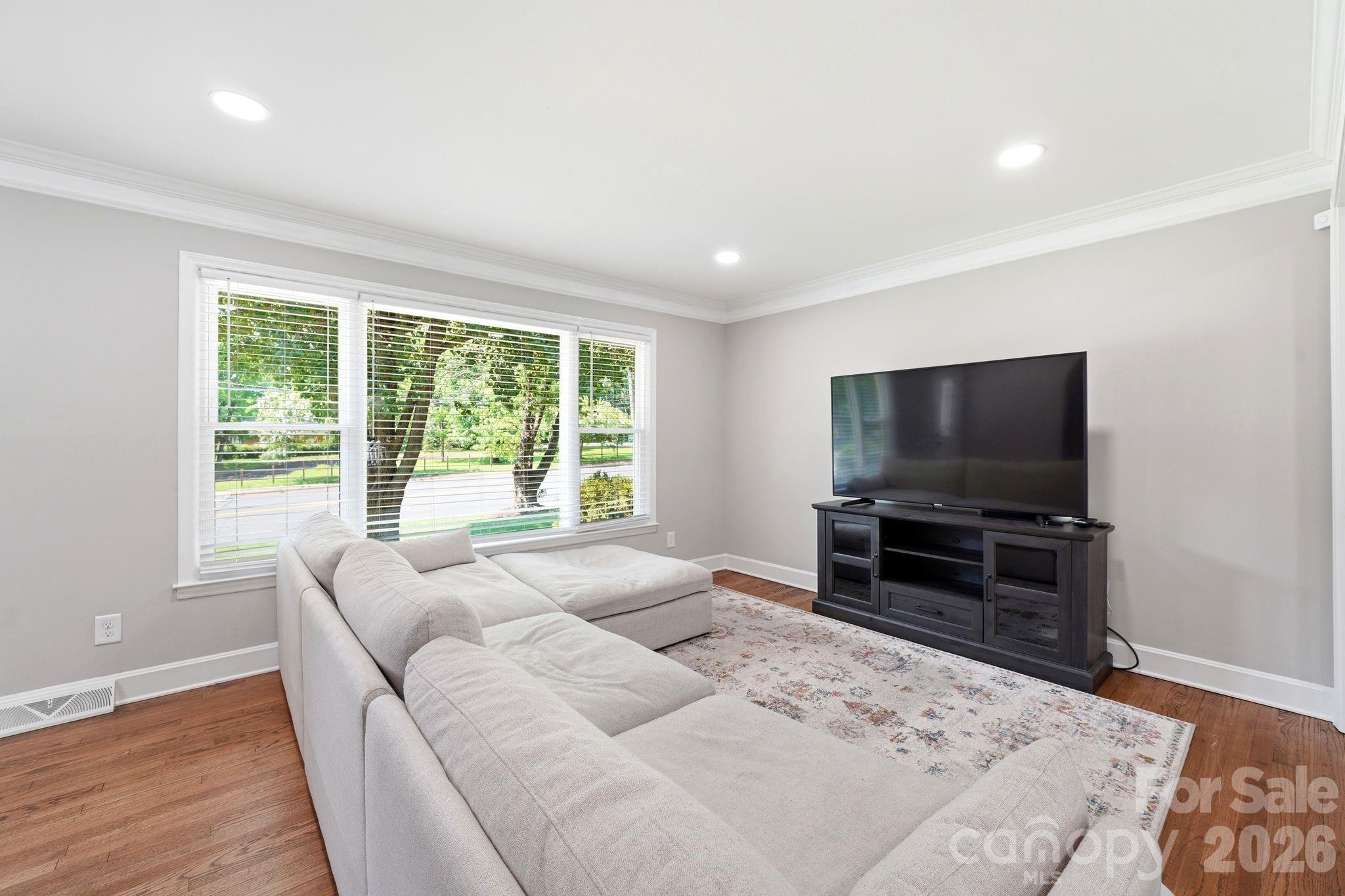 7552 Idlewild Road Charlotte, NC 28212 - Photo 30 of 40 a living room with furniture and a flat screen tv