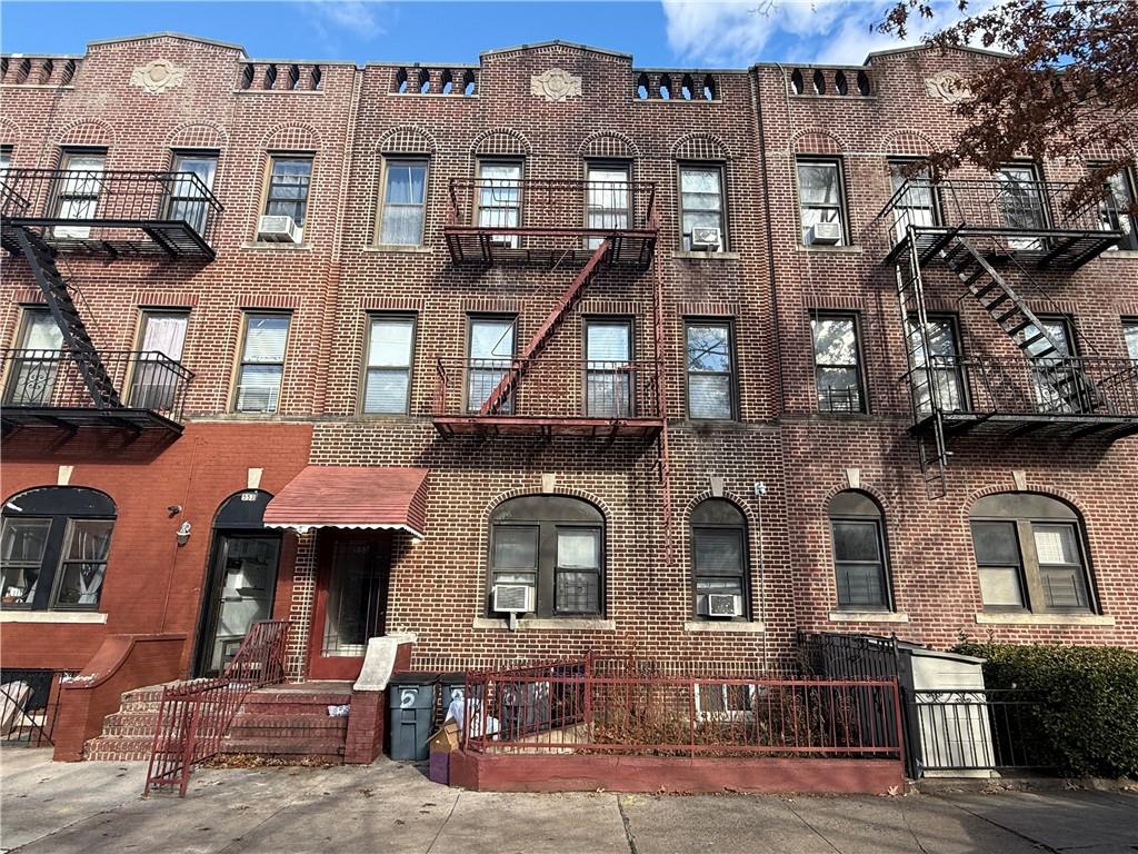 a front view of a residential apartment building with a yard