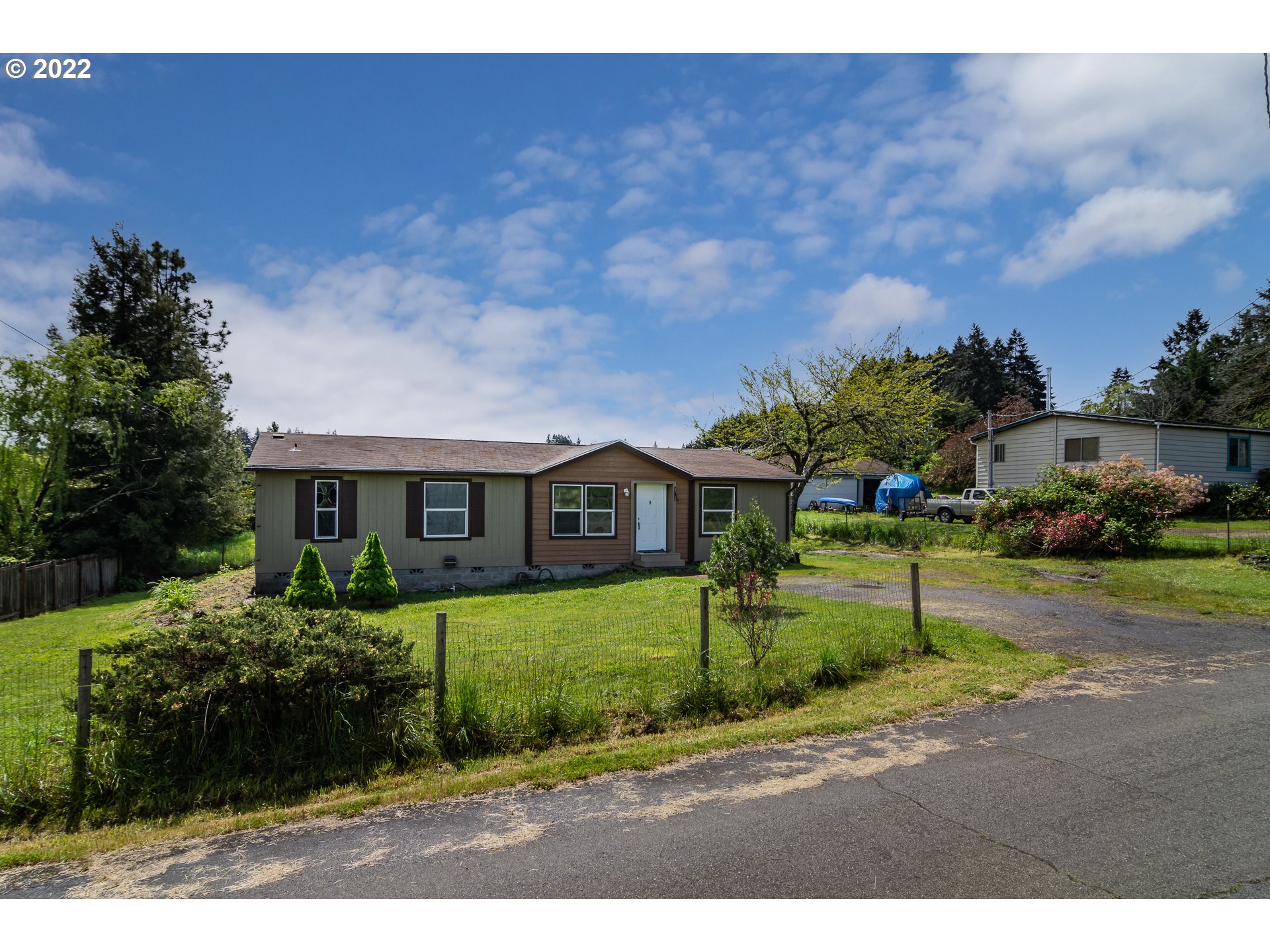 692 Mathis Hill Road Yoncalla, OR 97499 - Photo 1 of 31 a view of house in front of a big yard with potted plants