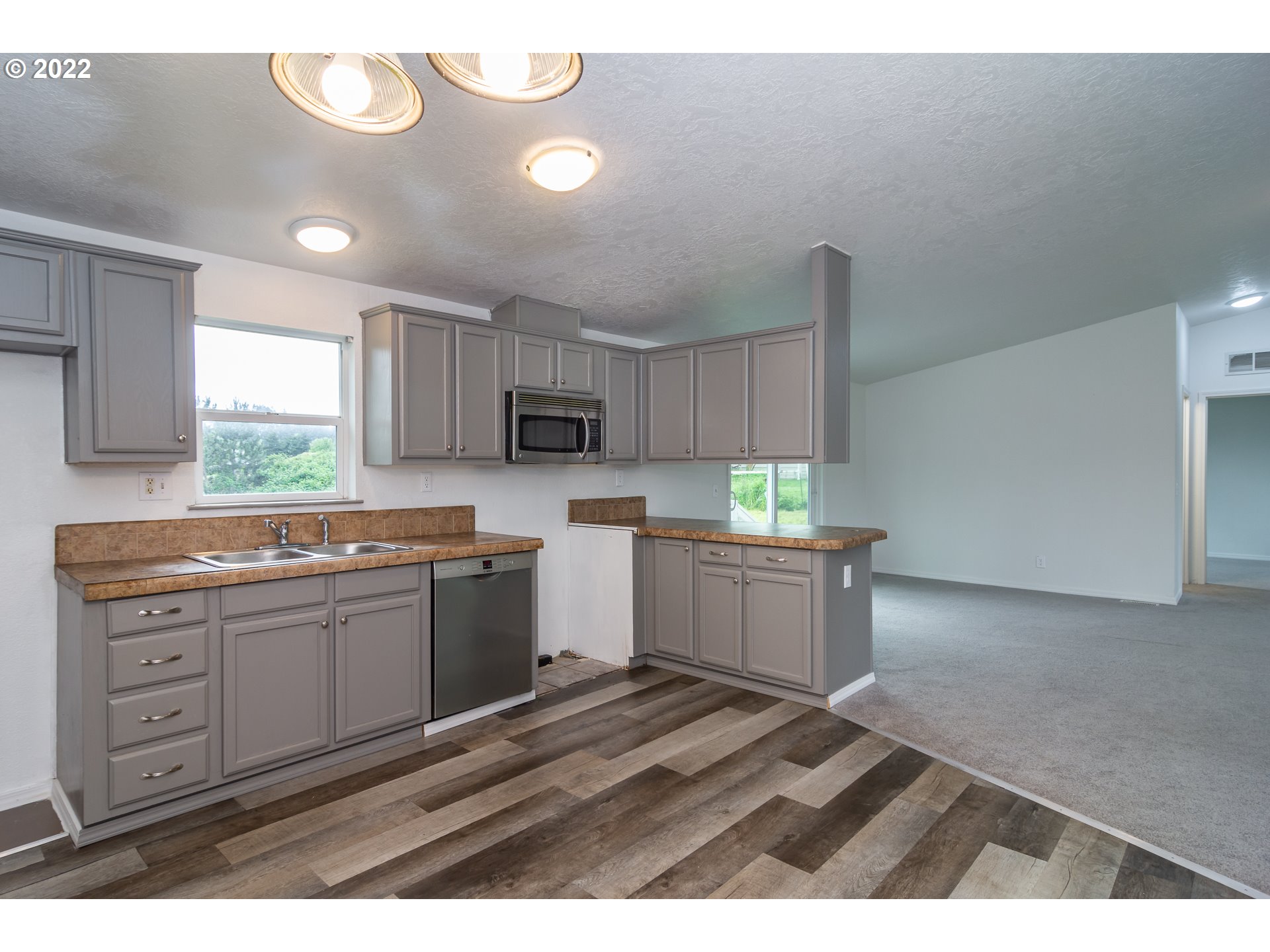 692 Mathis Hill Road Yoncalla, OR 97499 - Photo 12 of 31 a kitchen with a sink cabinets and wooden floor