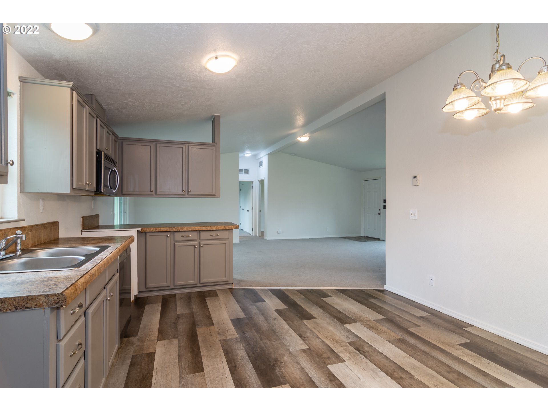 692 Mathis Hill Road Yoncalla, OR 97499 - Photo 13 of 31 a kitchen with a sink cabinets and wooden floor