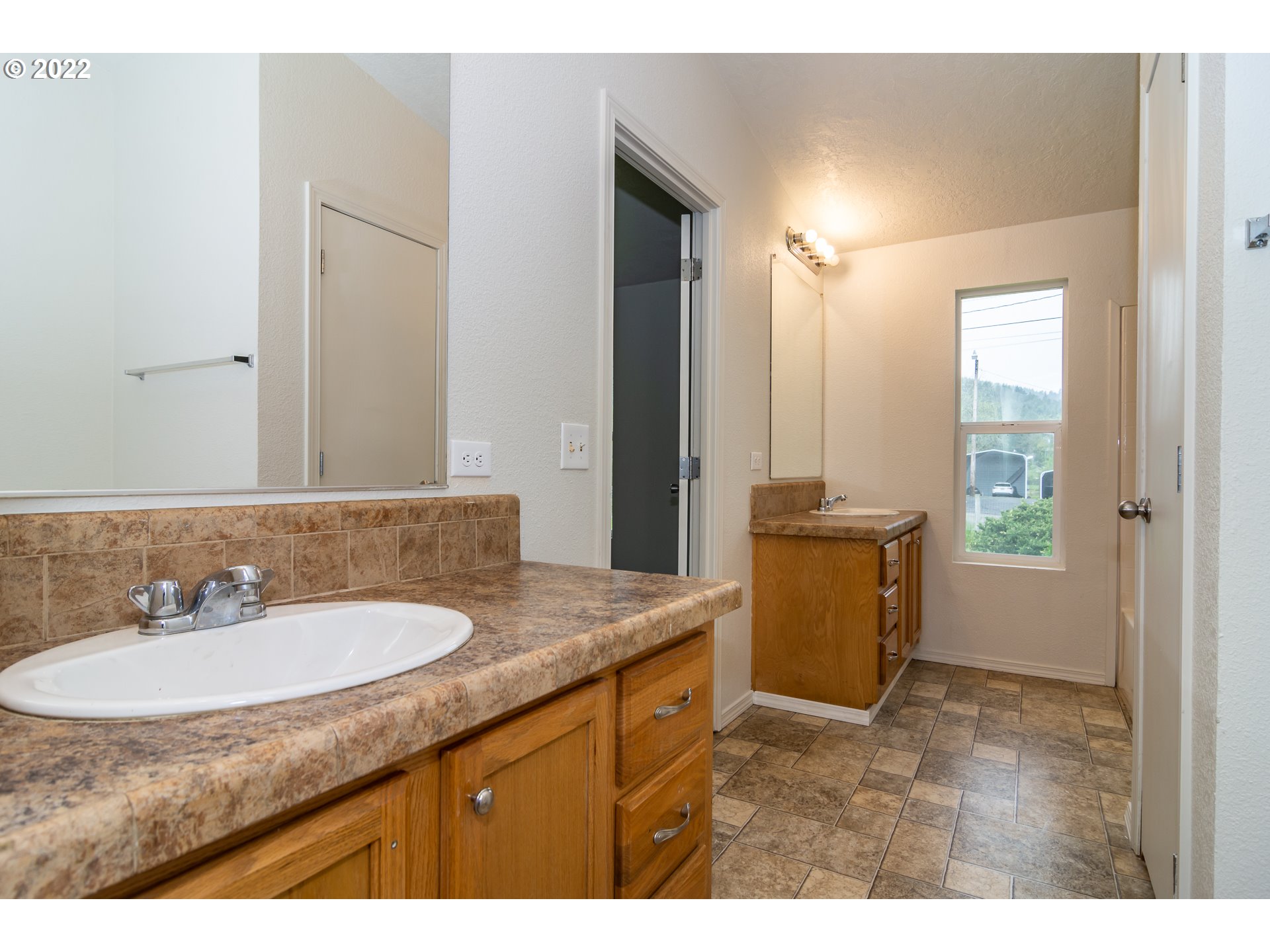 692 Mathis Hill Road Yoncalla, OR 97499 - Photo 18 of 31 a bathroom with a granite countertop sink and a mirror