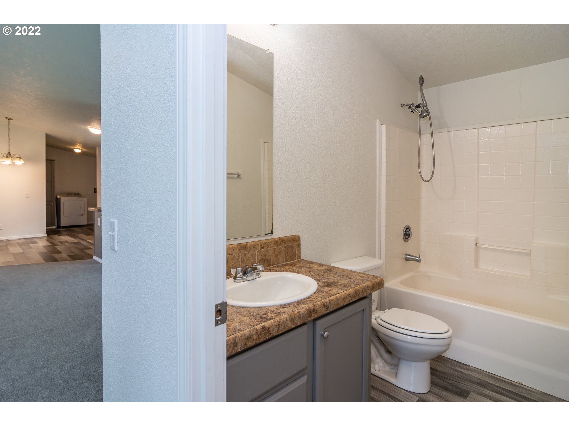 692 Mathis Hill Road Yoncalla, OR 97499 - Photo 25 of 31 a bathroom with a granite countertop sink toilet a shower and a mirror
