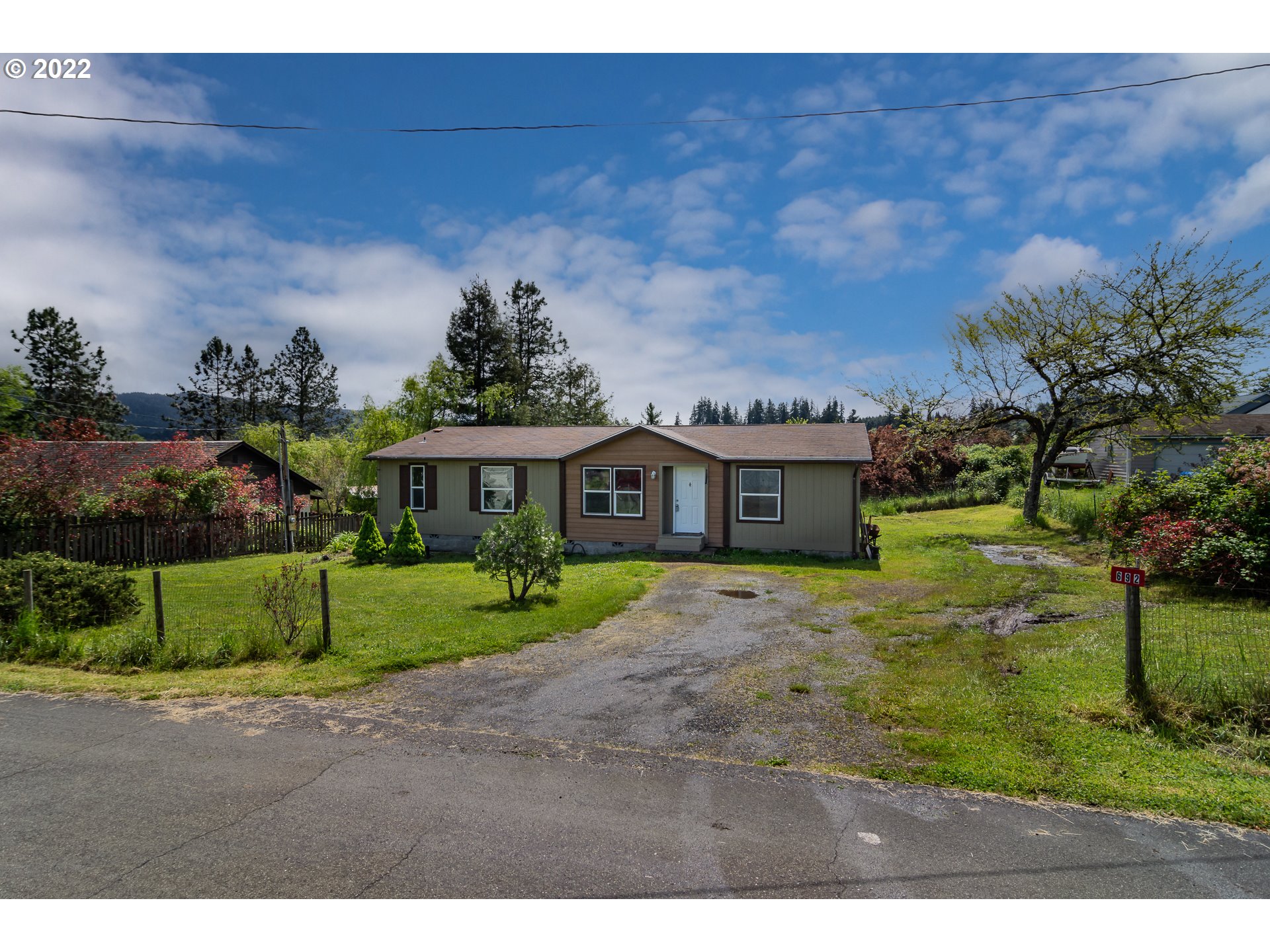 692 Mathis Hill Road Yoncalla, OR 97499 - Photo 30 of 31 a view of a big house with a big yard and potted plants