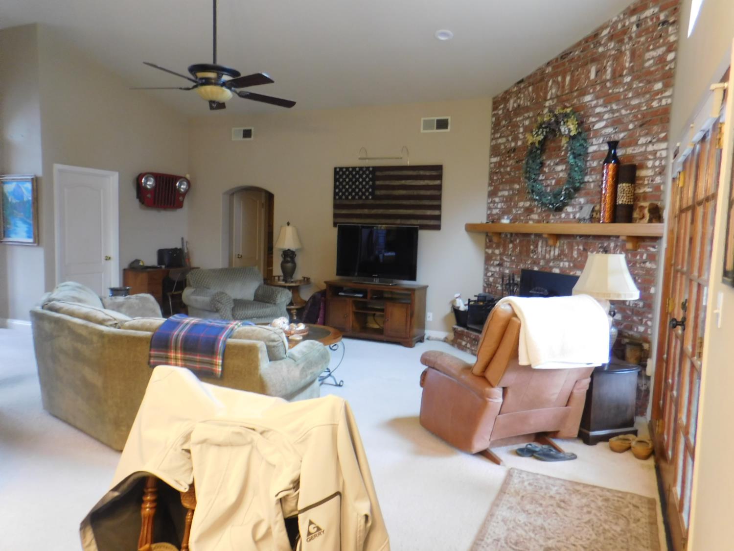3215 Tragon Street Madera, CA 93637 - Photo 5 of 13 a living room with furniture and a fireplace