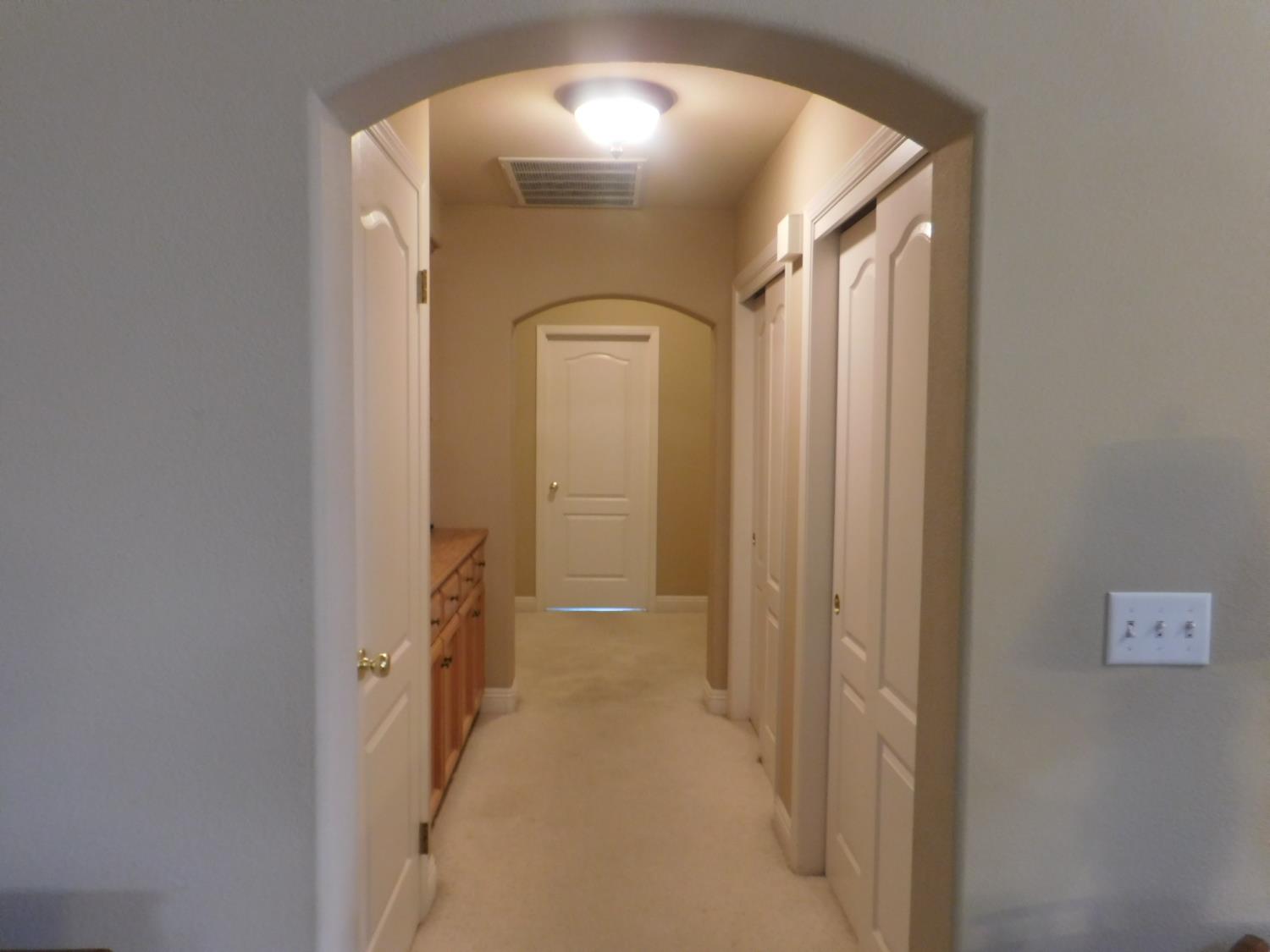 3215 Tragon Street Madera, CA 93637 - Photo 9 of 13 a view of a hallway with wooden shelves