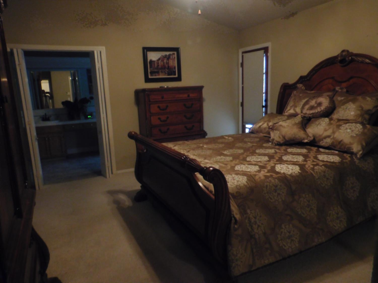 3215 Tragon Street Madera, CA 93637 - Photo 10 of 13 a bedroom with a bed and dresser