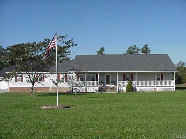 1428 Rolesville Road Wake Forest, NC 27587 - Photo 1 of 1 a front view of house with a garden and trees