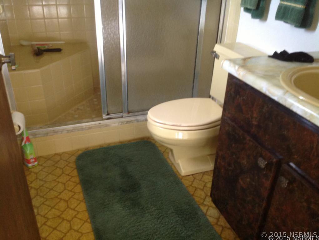 1307 South Riverside Drive Edgewater, FL 32132 - Photo 4 of 8 a bathroom with a sink and a toilet