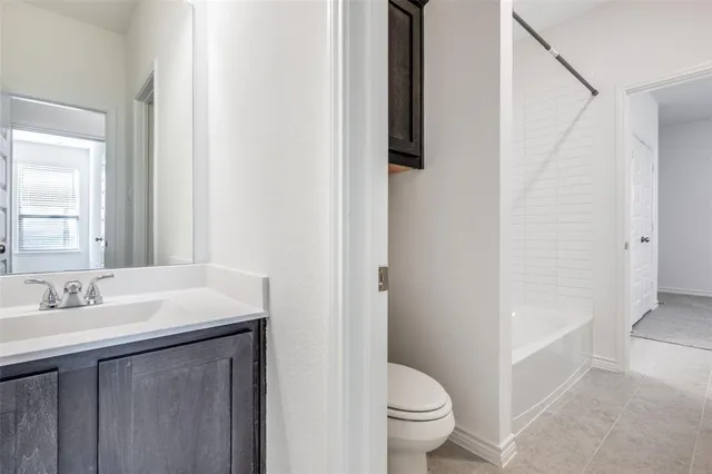 a view of a house with a wooden fence