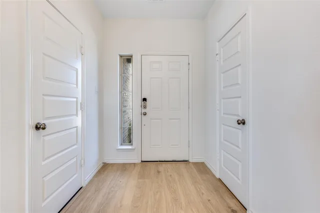 a view of a hallway with wooden floor