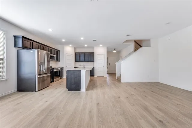 a kitchen with a refrigerator and a sink