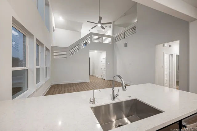 a kitchen with a sink a counter top space and stainless steel appliances