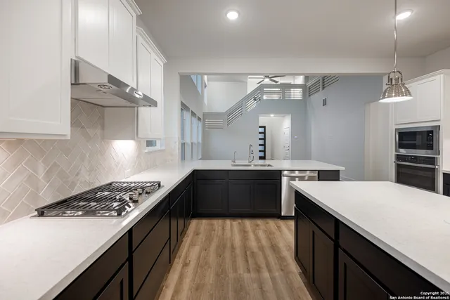 a kitchen with a stove and a refrigerator