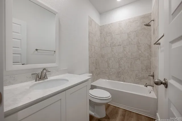 a bathroom with a sink a toilet and bathtub