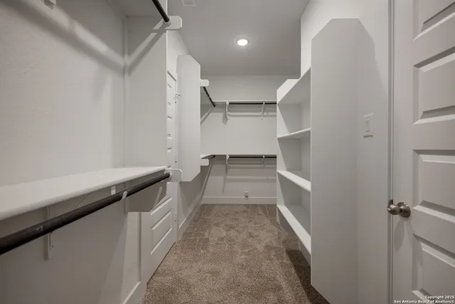 a bathroom with a granite countertop sink a toilet and a mirror