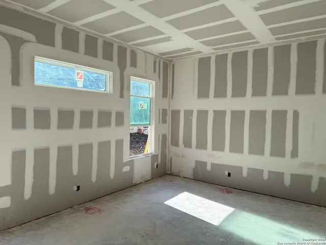 a view of an empty room with windows