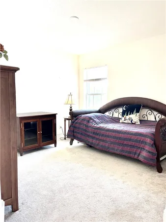 a bedroom with a bed and a fireplace