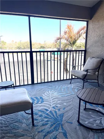 a view of a chairs and table in the balcony
