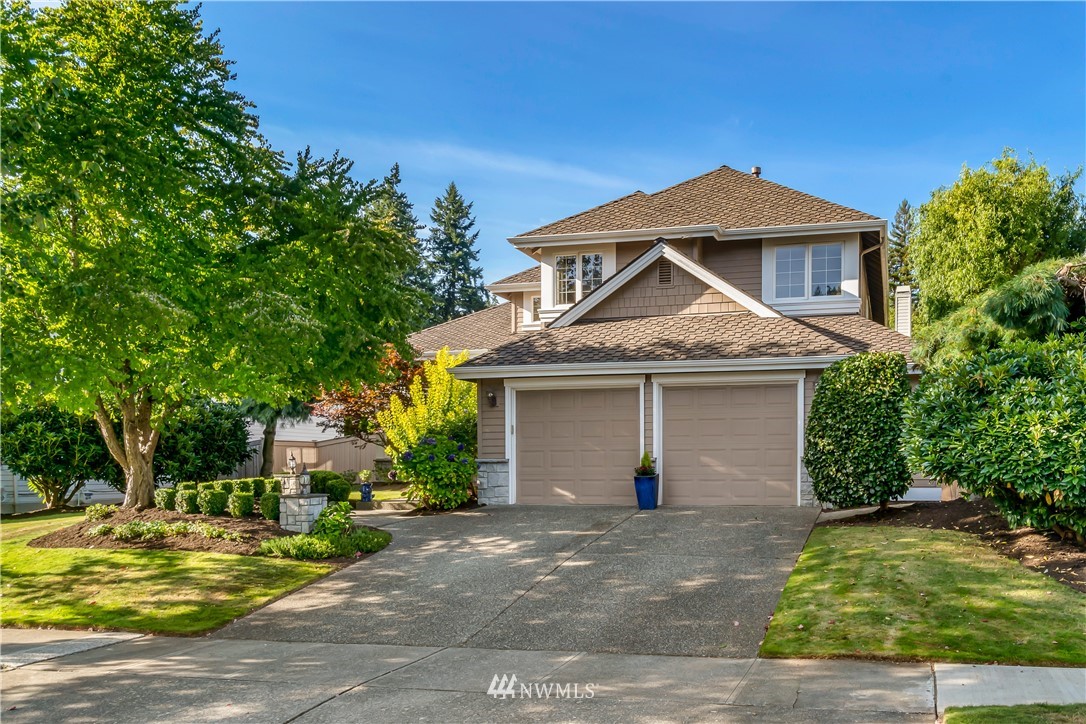 3009 214th Street Southeast Bothell, WA 98021 - Photo 2 of 36 a front view of a house with a yard and garage