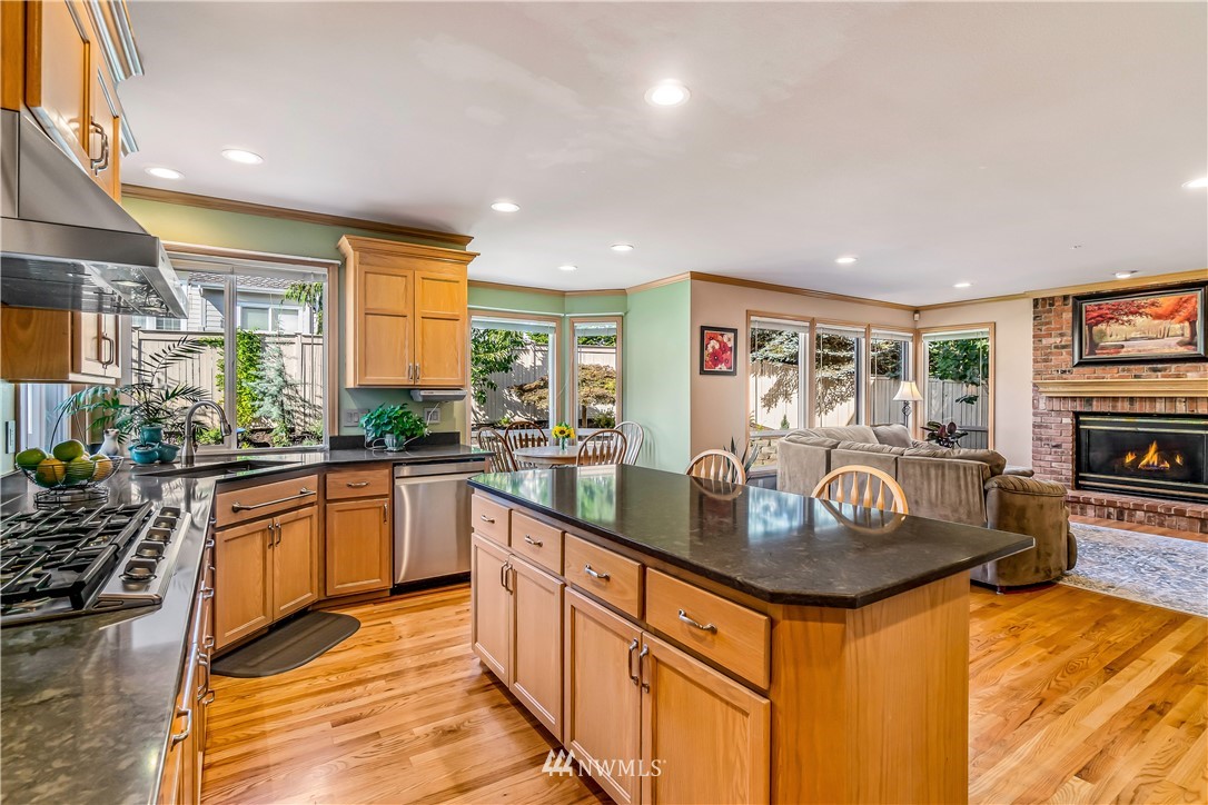 3009 214th Street Southeast Bothell, WA 98021 - Photo 13 of 36 a kitchen with kitchen island granite countertop a stove and a sink
