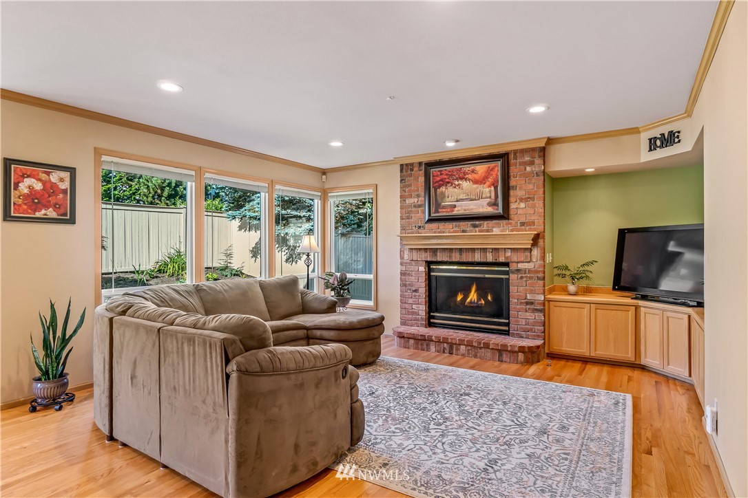 3009 214th Street Southeast Bothell, WA 98021 - Photo 18 of 36 a living room with furniture and a fireplace