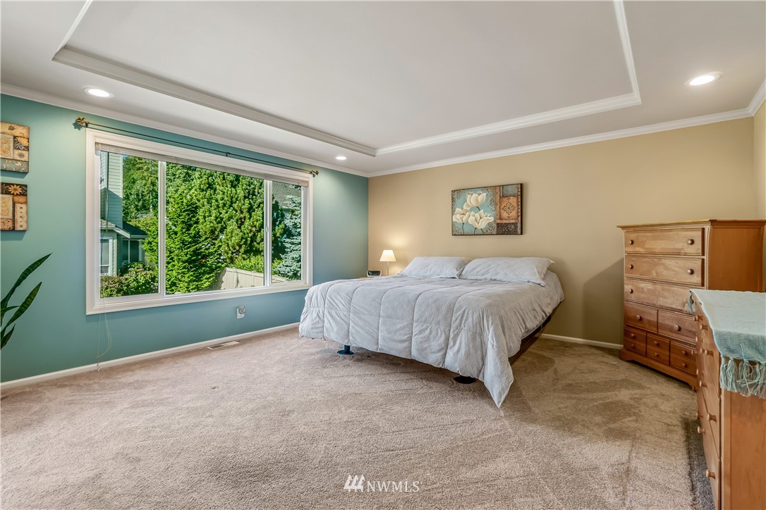 3009 214th Street Southeast Bothell, WA 98021 - Photo 23 of 36 a bedroom with a bed and a large window