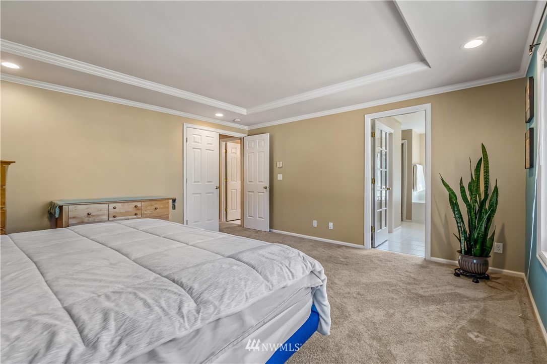 3009 214th Street Southeast Bothell, WA 98021 - Photo 24 of 36 a bedroom with a bed and a potted plant