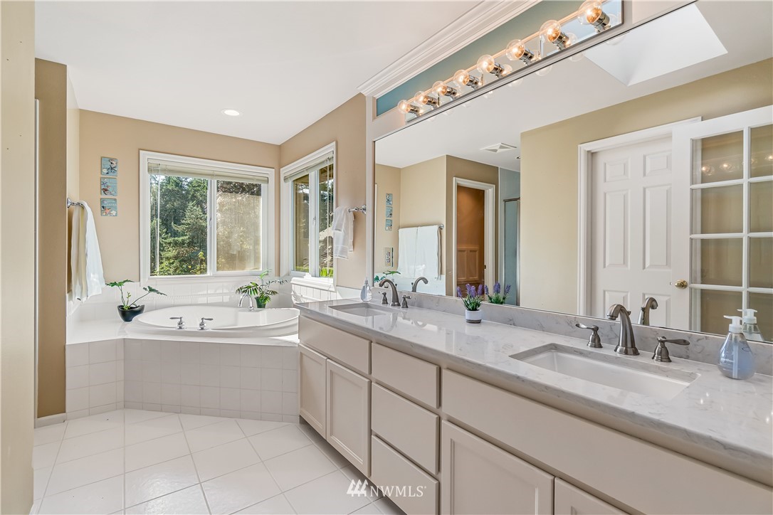 3009 214th Street Southeast Bothell, WA 98021 - Photo 25 of 36 a bathroom with a granite countertop sink mirror and bathtub