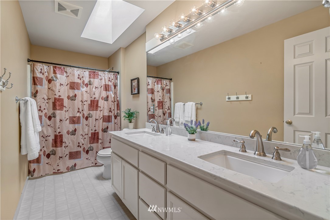 3009 214th Street Southeast Bothell, WA 98021 - Photo 29 of 36 a bathroom with a double vanity sink mirror and shower