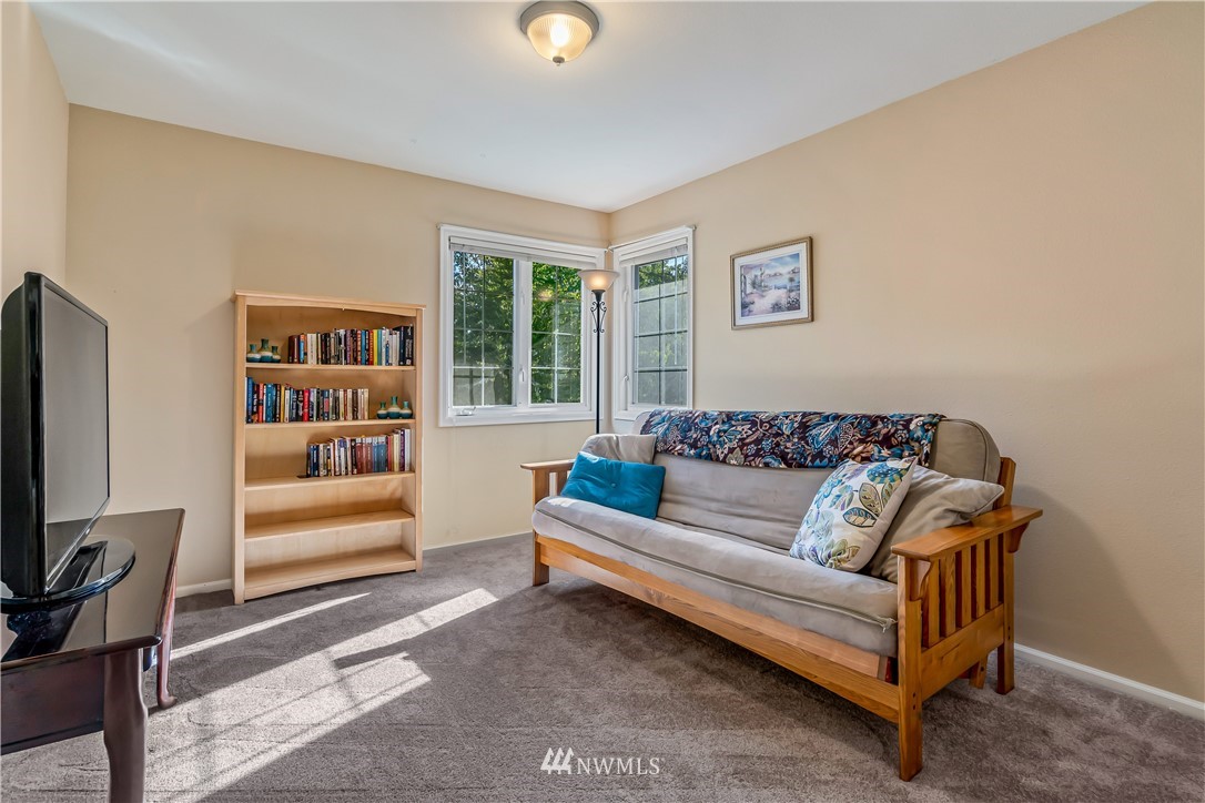 3009 214th Street Southeast Bothell, WA 98021 - Photo 30 of 36 a living room with furniture and a bookshelf