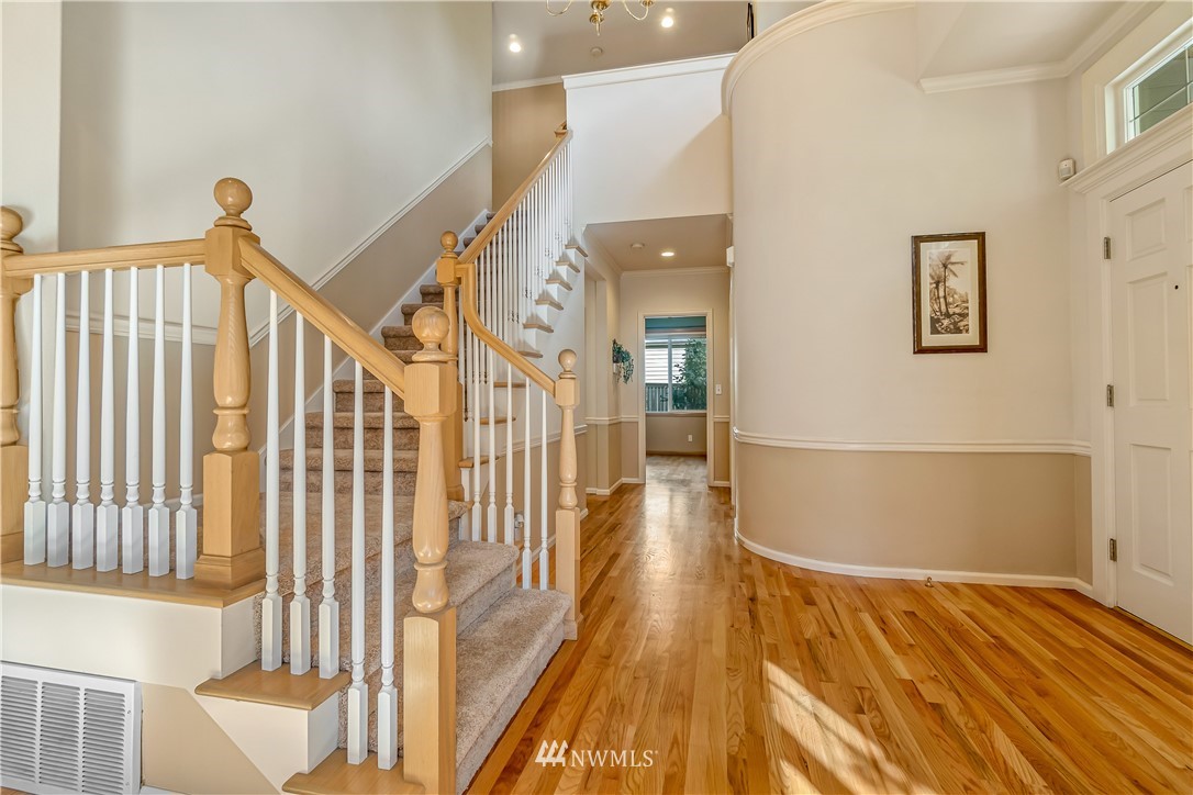 3009 214th Street Southeast Bothell, WA 98021 - Photo 5 of 36 a view of a hallway with wooden floor and staircase