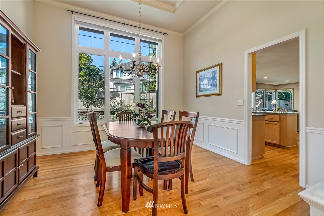 3009 214th Street Southeast Bothell, WA 98021 - Photo 10 of 36 a view of a dining room with furniture and wooden floor