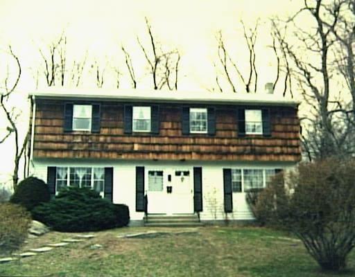 96 Rodgers Road, Unit 23 Fairfield, CT 06824 - Photo 1 of 1 a front view of a house with a yard