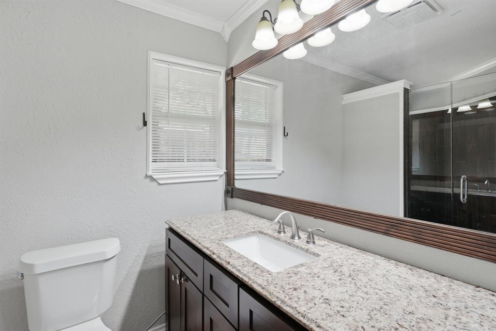 1108 Billie Ruth Lane Hurst, TX 76053 - Photo 19 of 27 Bathroom vanity featuring a light granite-style countertop with an undermount sink and brushed nickel faucet