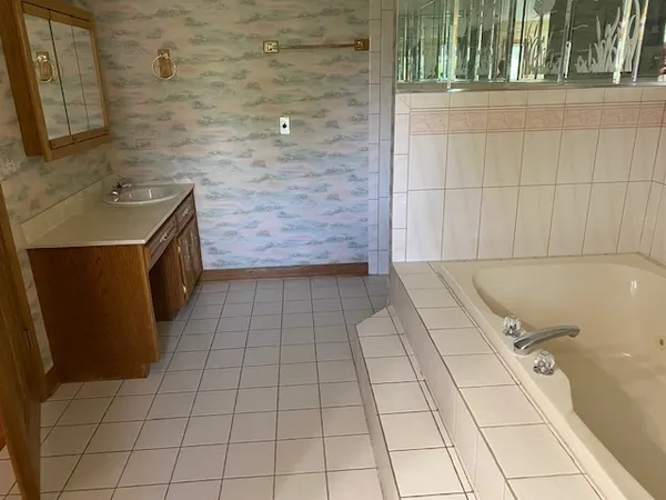 a bathroom with a sink a vanity and a mirror
