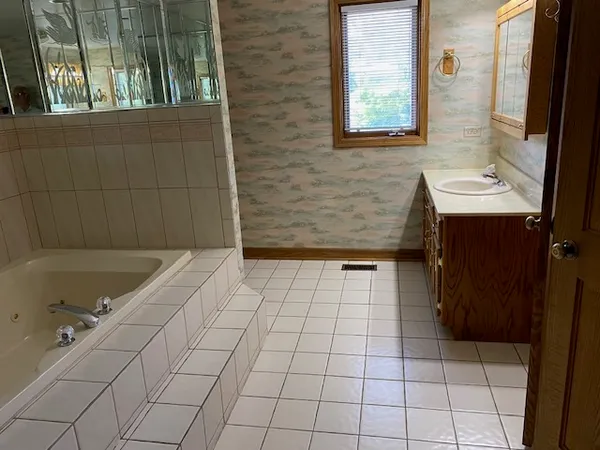 a bathroom with a bathtub sink and window