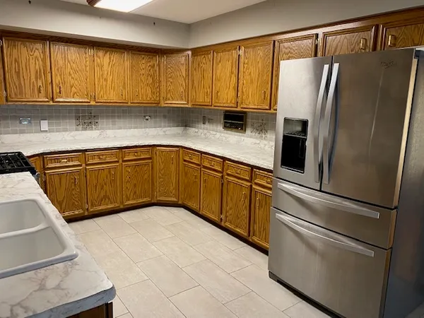 a kitchen with stainless steel appliances granite countertop a refrigerator sink and cabinets