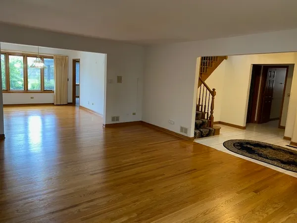 a room with wooden floor and furniture