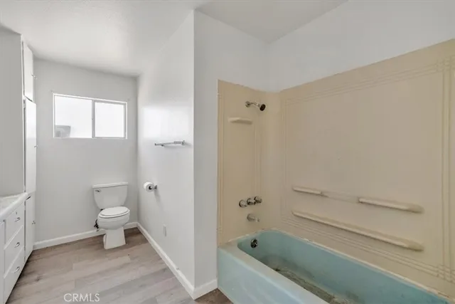 a bathroom with a toilet and shower