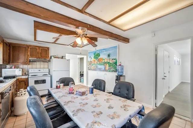 an empty room with fan and windows