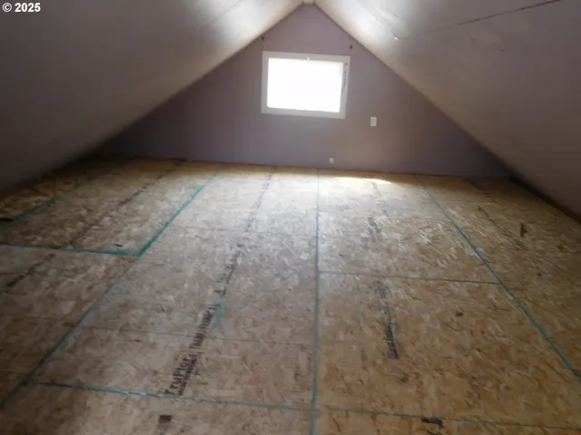 an empty room with a empty space and windows