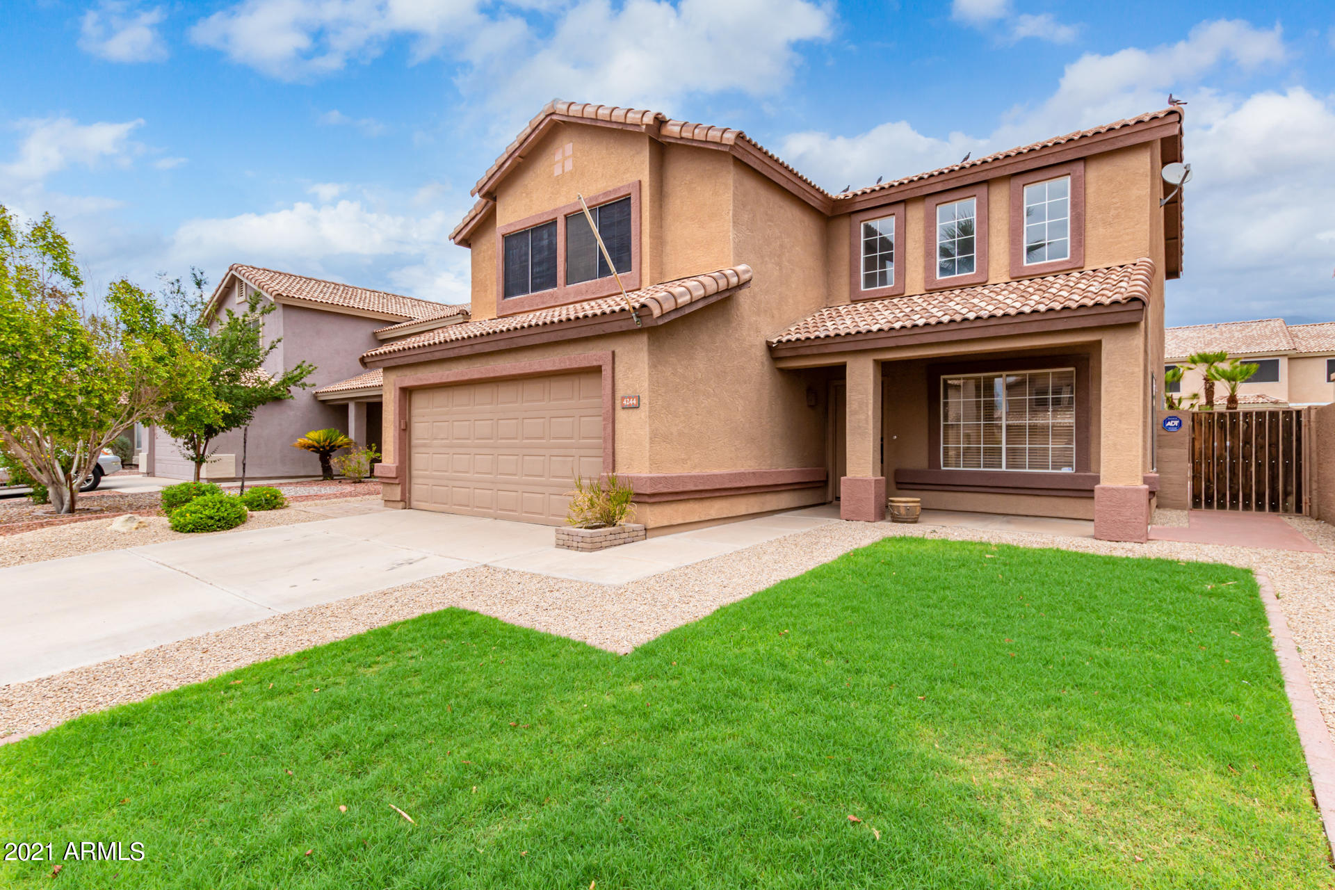 4244 East Raven Road Phoenix, AZ 85044 - Photo 1 of 31 a front view of a house with a yard and garage