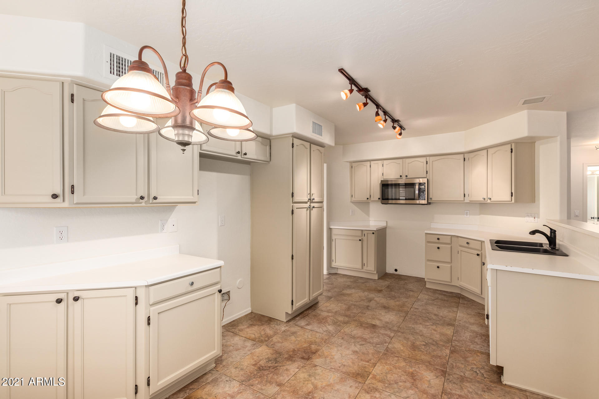 4244 East Raven Road Phoenix, AZ 85044 - Photo 11 of 31 a kitchen with white cabinets and appliances