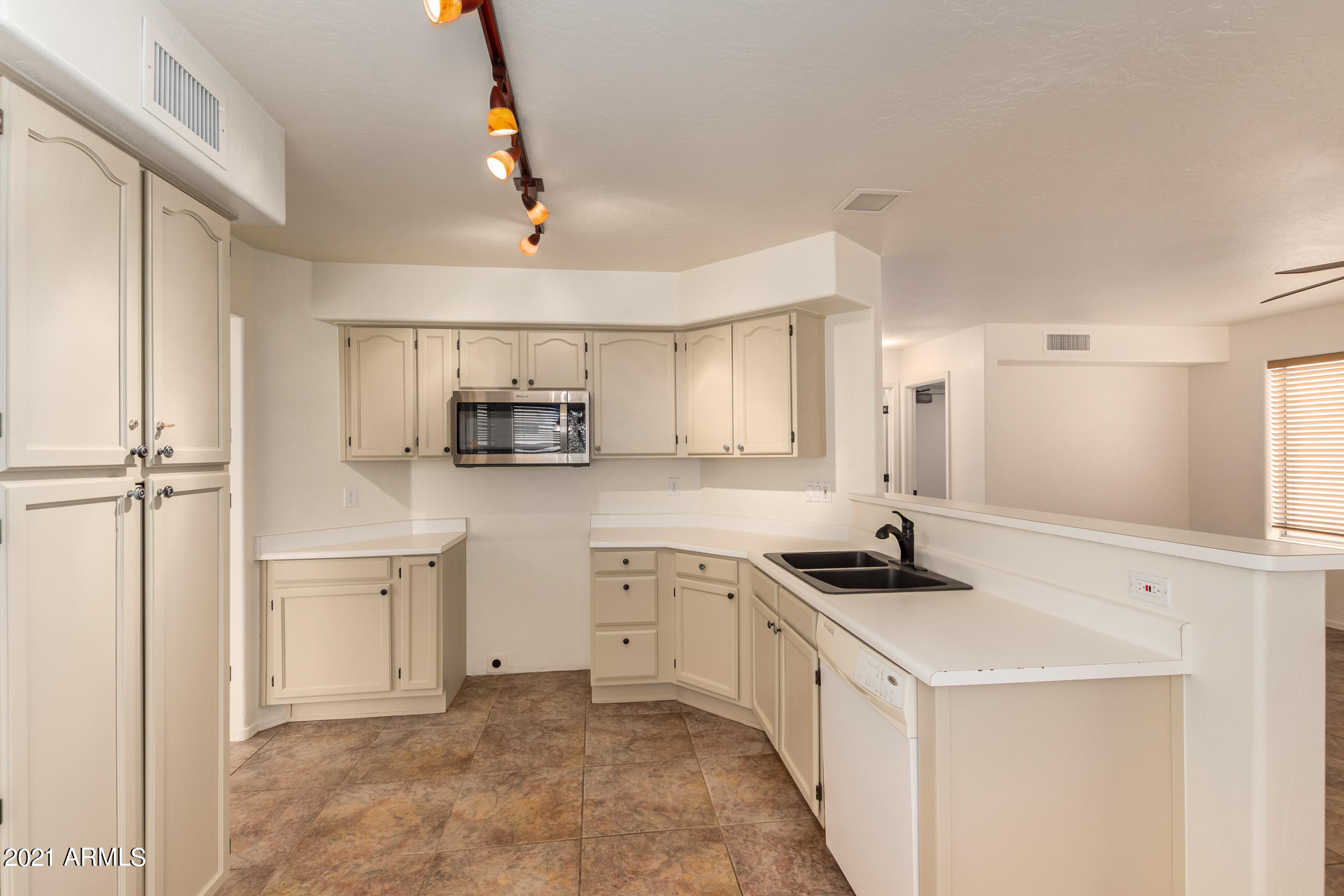 4244 East Raven Road Phoenix, AZ 85044 - Photo 12 of 31 a kitchen with white cabinets and appliances