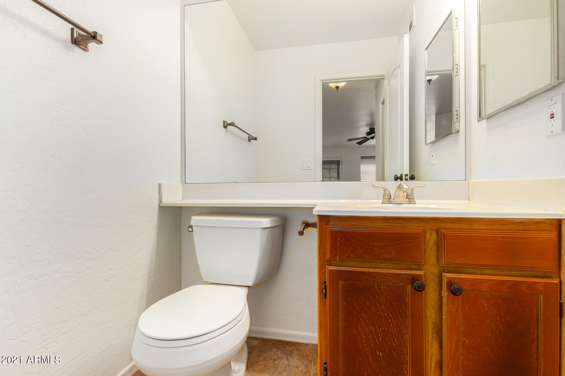 4244 East Raven Road Phoenix, AZ 85044 - Photo 14 of 31 a bathroom with a toilet sink and mirror