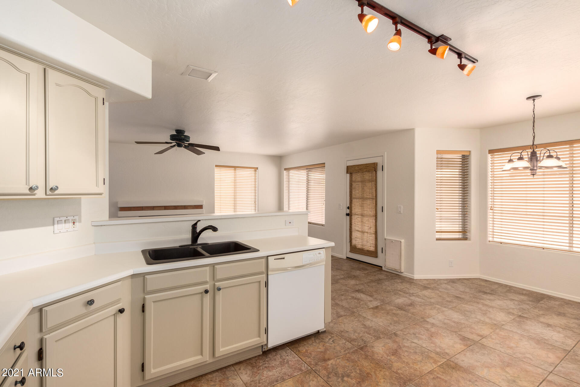 4244 East Raven Road Phoenix, AZ 85044 - Photo 15 of 31 a kitchen with white cabinets and window