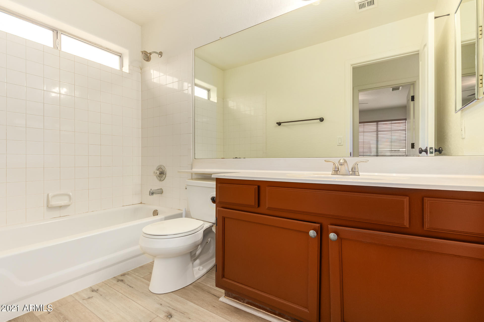 4244 East Raven Road Phoenix, AZ 85044 - Photo 18 of 31 a bathroom with a sink toilet a mirror and shower